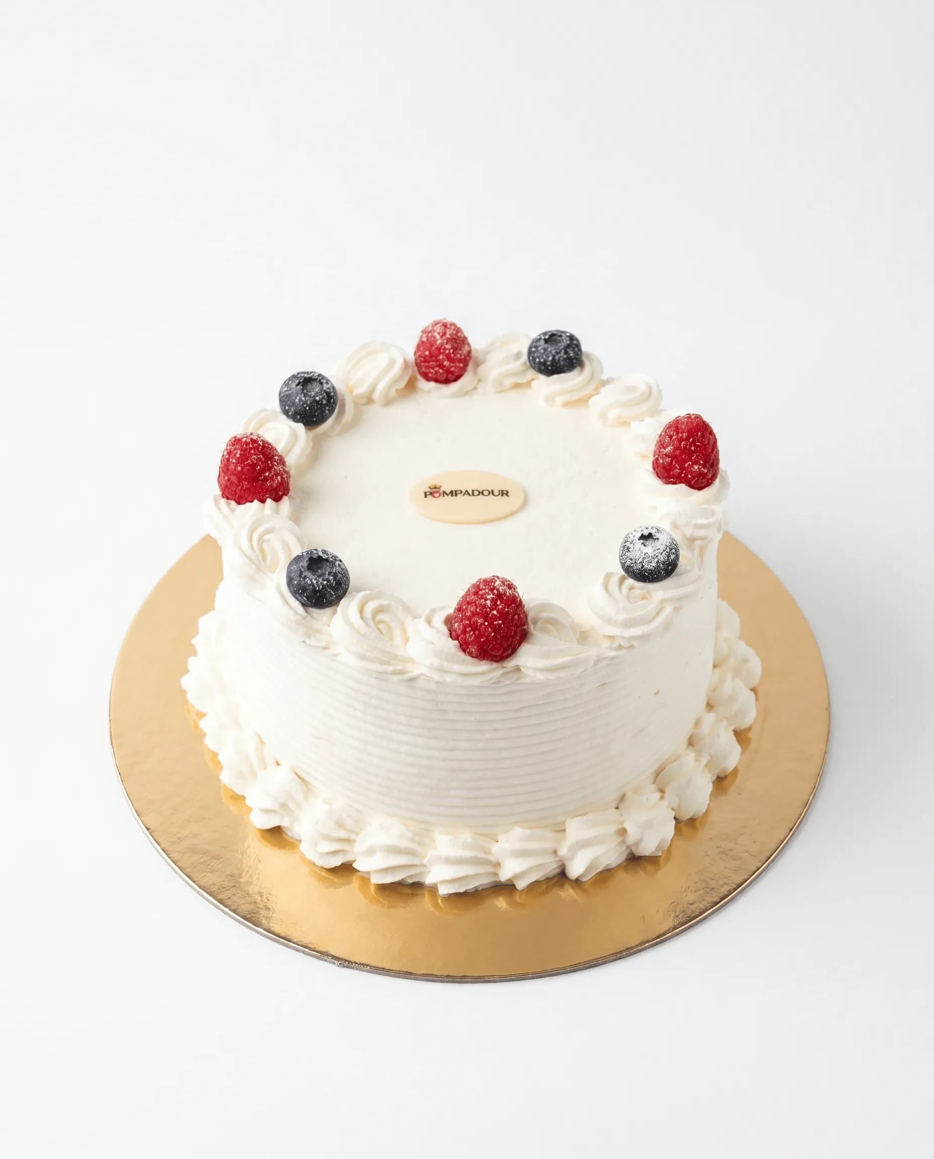 Mixed Berry Cake — Delicate vanilla génoise layered with silky vanilla crème and a medley of fresh seasonal berries. A signature French-inspired celebration cake
